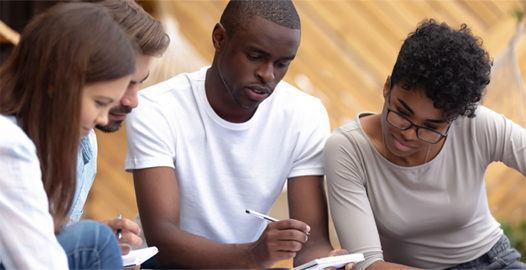 An image of a group of students working on computer tablets.