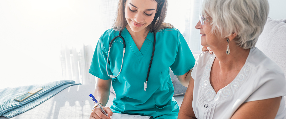 An image of a young medical student assisting an elderly woman.