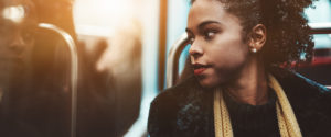 An image of a young woman looking out a window.