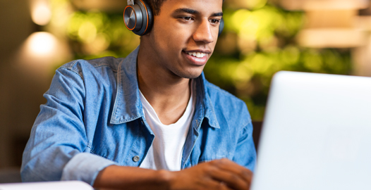 An image of a young man working on his laptop computer.