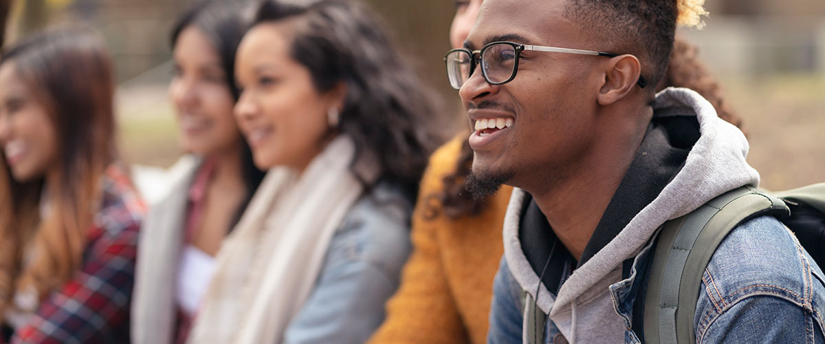 A group of students talking and laughter together.