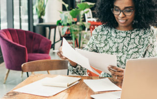 An image of a woman looking over paperwork