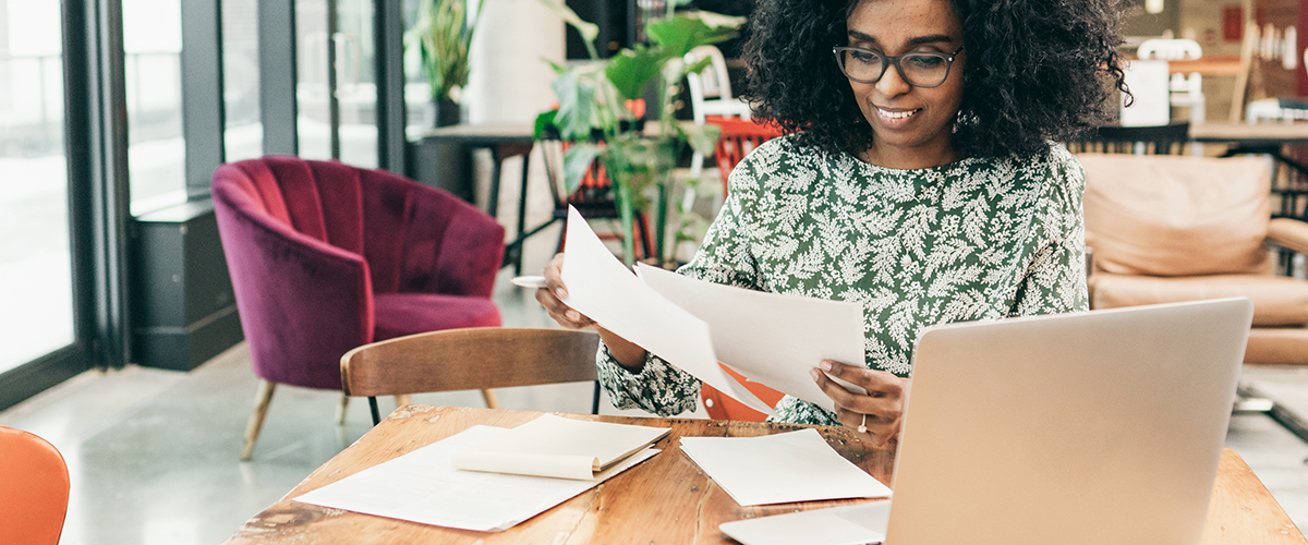 An image of a woman looking over paperwork