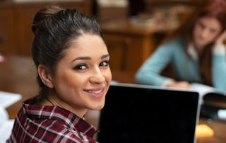 An image of a young woman working in the library.
